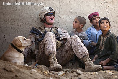 Defense_gov_News_Photo_111122-M-MM918-004_-_U_S__Marine_Corps_Lance_Cpl__Isaiah_Schult_an_improvised_explosive_device_dog_handler_jokes_with_Afghan_children_and_an_Afghan_National_Police.jpg