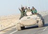 thumb_Iraqi_military_men_riding_on_tank.